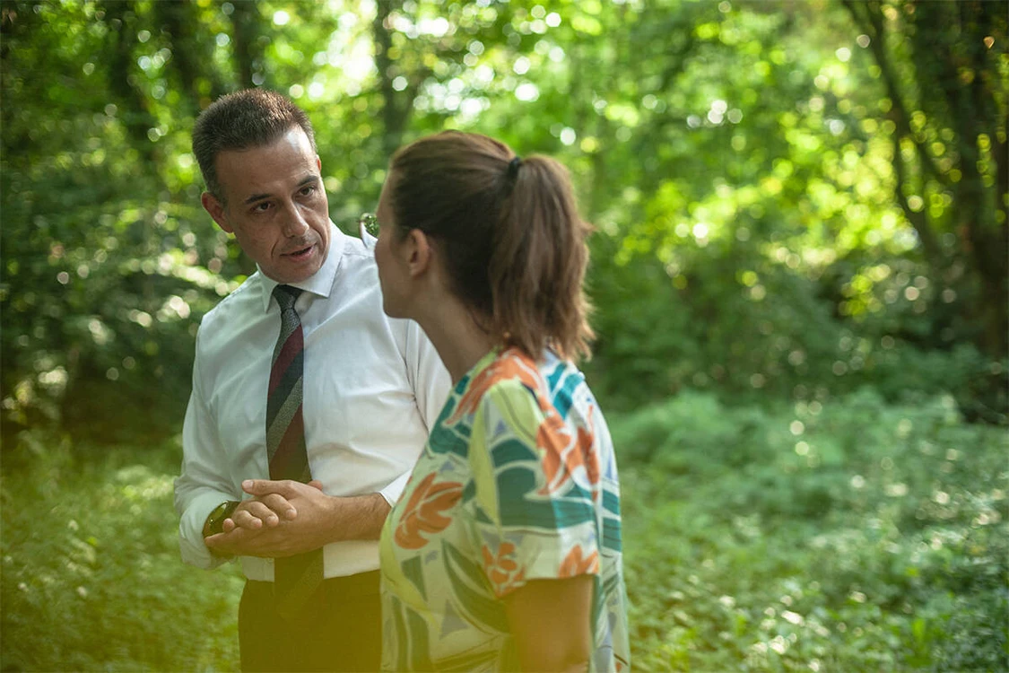 Mann spaziert mit Frau im wald und redet mit ihr